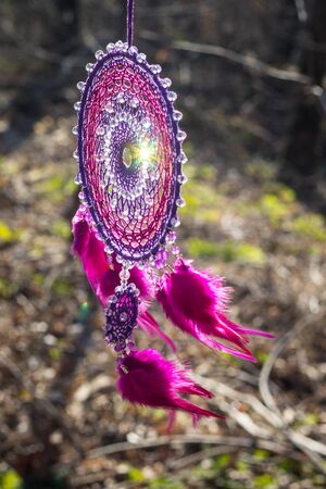 Colorful Dreamcatcher made of feathers leather beads and ropes, hanging, handmadeの写真素材