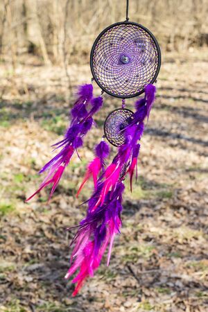 Colorful Dreamcatcher made of feathers leather beads and ropes, hanging, handmadeの写真素材