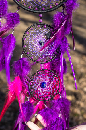 Colorful Dreamcatcher made of feathers leather beads and ropes, hanging, handmadeの写真素材