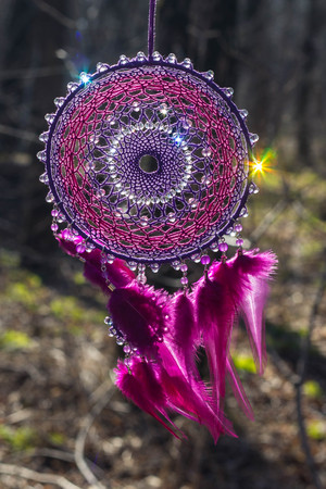 Colorful Dreamcatcher made of feathers leather beads and ropes, hanging, handmadeの写真素材