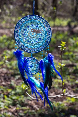 Colorful Dreamcatcher made of feathers leather beads and ropes, hanging, handmadeの写真素材