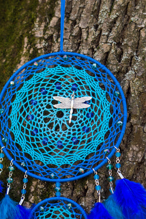 Colorful Dreamcatcher made of feathers leather beads and ropes, hanging, handmadeの写真素材