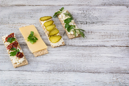various crispbread slices on white woden kitchen table, top viewの写真素材