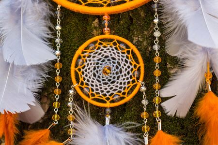 Colorful Dreamcatcher made of feathers leather beads and ropes, hanging, handmadeの写真素材