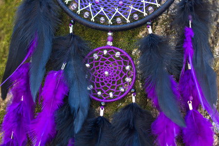 Colorful Dreamcatcher made of feathers leather beads and ropes, hanging, handmadeの写真素材