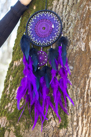Colorful Dreamcatcher made of feathers leather beads and ropes, hanging, handmadeの写真素材