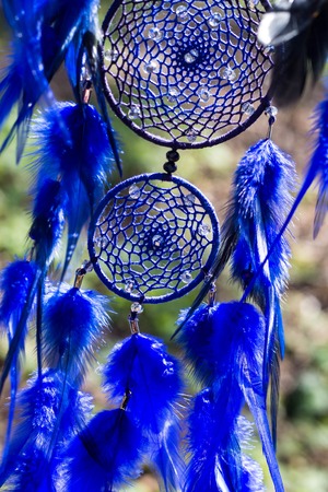 Colorful Dreamcatcher made of feathers leather beads and ropes, hanging, handmadeの写真素材