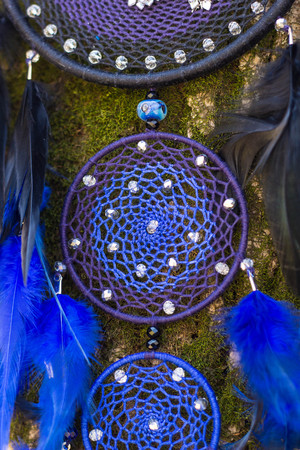 Colorful Dreamcatcher made of feathers leather beads and ropes, hanging, handmadeの写真素材