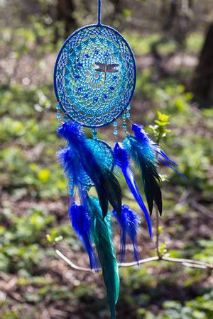 Colorful Dreamcatcher made of feathers leather beads and ropes, hanging, handmadeの写真素材