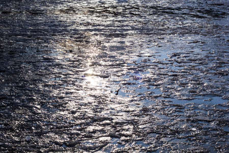 abstract reflections in melting the icy cobblestones. path of lightの写真素材