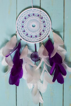 Colorful Dreamcatcher made of feathers leather beads and ropes, hanging, handmadeの写真素材