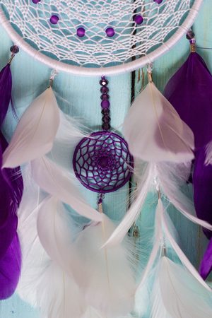 Colorful Dreamcatcher made of feathers leather beads and ropes, hanging, handmadeの写真素材