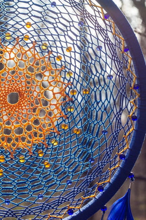 Colorful Dreamcatcher made of feathers leather beads and ropes, hanging, handmadeの写真素材