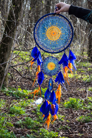Colorful Dreamcatcher made of feathers leather beads and ropes, hanging, handmadeの写真素材