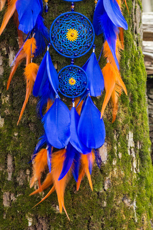 Colorful Dreamcatcher made of feathers leather beads and ropes, hanging, handmadeの写真素材