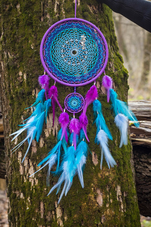 Colorful Dreamcatcher made of feathers leather beads and ropes, hanging, handmadeの写真素材
