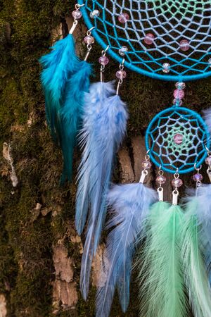 Colorful Dreamcatcher made of feathers leather beads and ropes, hanging, handmadeの写真素材
