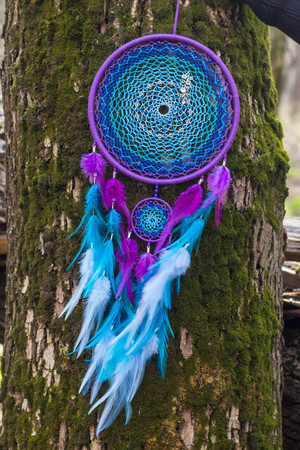 Colorful Dreamcatcher made of feathers leather beads and ropes, hanging, handmadeの写真素材