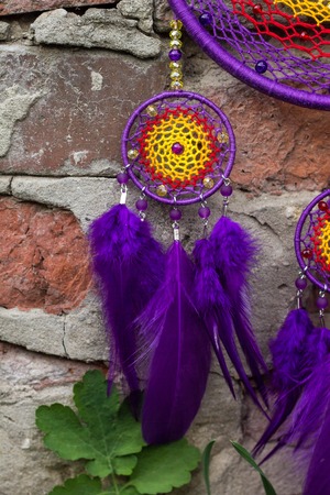 Colorful Dreamcatcher made of feathers leather beads and ropes, hanging, handmadeの写真素材