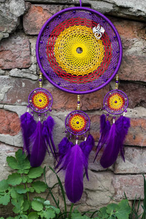 Colorful Dreamcatcher made of feathers leather beads and ropes, hanging, handmadeの写真素材