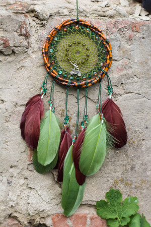 Colorful Dreamcatcher made of feathers leather beads and ropes, hanging, handmadeの写真素材