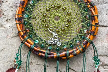 Colorful Dreamcatcher made of feathers leather beads and ropes, hanging, handmadeの写真素材