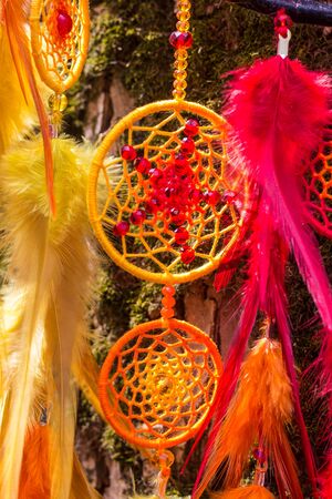 Colorful Dreamcatcher made of feathers leather beads and ropes, hanging, handmadeの写真素材