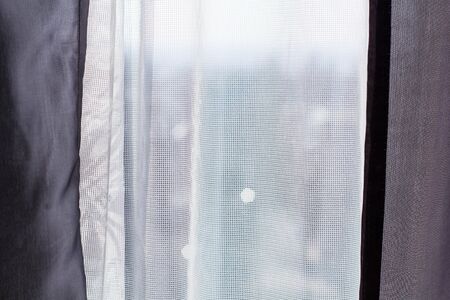 White and gray curtains at the windows for backgroundの写真素材