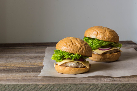 Close-up of home made tasty burgers on wooden table.の写真素材