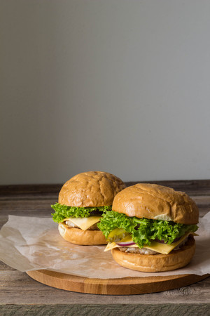 Close-up of home made tasty burgers on wooden table.の写真素材
