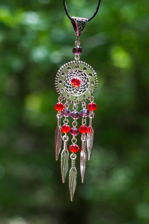 Colorful Dreamcatcher made of feathers leather beads and ropes, hanging, handmadeの写真素材