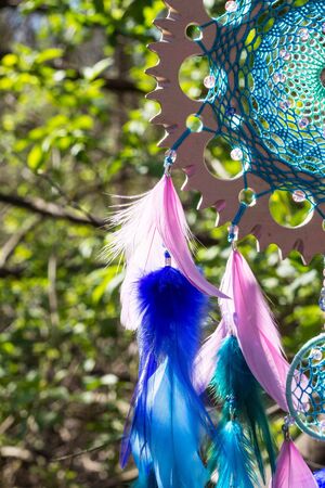 Colorful Dreamcatcher made of feathers leather beads and ropes, hanging, handmadeの写真素材