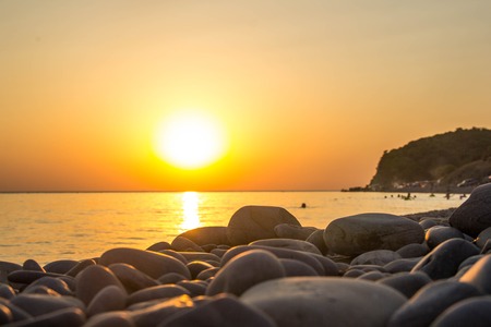 Beautiful blazing sunset landscape at black sea and orange sky above it as a background.の写真素材