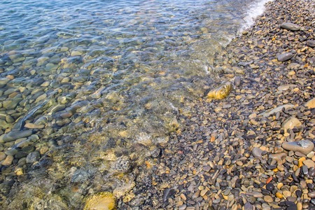 Sea and pebbles underwater in a beach. Pebble background.の写真素材