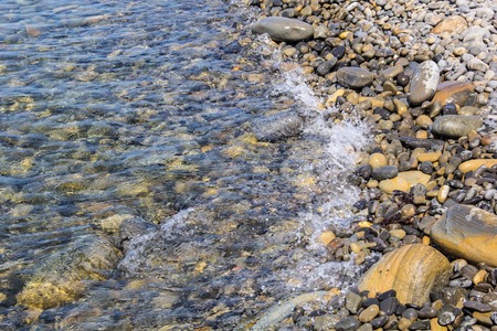 Sea and pebbles underwater in a beach. Pebble background.の写真素材