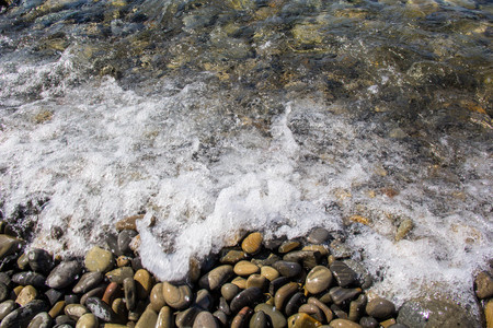 Sea and pebbles underwater in a beach. Pebble background.の写真素材