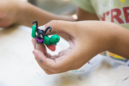 Child playing with colorful clay making animal figures. closeup on hands.の写真素材