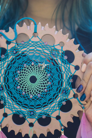 Blue dreamcatcher with star made of feathers leather beads and ropes, hangingの写真素材