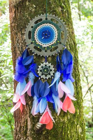 Blue dreamcatcher with star made of feathers leather beads and ropes, hangingの写真素材
