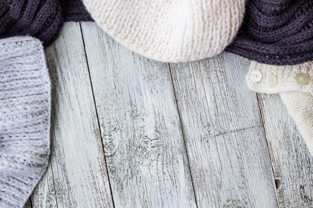 Fragment of knitting clothes on white wooden background.の写真素材