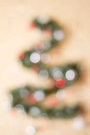 Christmas fir tree out of focus on a white background. Reflexes bokeh, repeating the shape of triangular shape.の写真素材