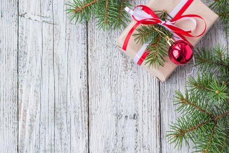 Christmas background with decorations and gift boxes on white wooden board. Copy space, top view.の写真素材