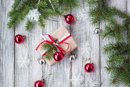 Christmas background with decorations and gift boxes on white wooden board. Copy space, top view.の写真素材