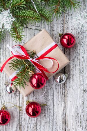 Christmas background with decorations and gift boxes on white wooden board. Copy space, top view.の写真素材