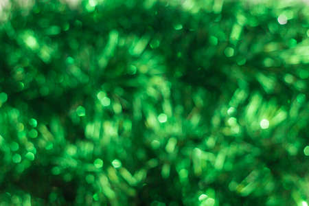 Defocused abstract green background. Blurred holiday bokeh.の写真素材