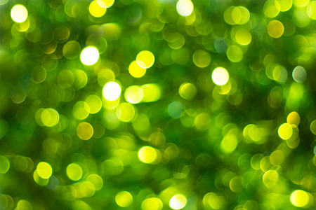Defocused abstract green background. Blurred holiday bokeh.の写真素材
