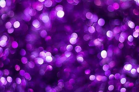 Purple shiny glitter holiday beautiful abstract blur bokeh background.の写真素材
