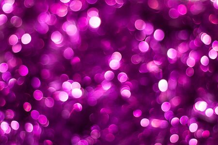 Purple shiny glitter holiday beautiful abstract blur bokeh background.の写真素材