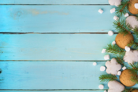 Christmas border with gingerbread, marshmallow and branch of fir tree.の写真素材