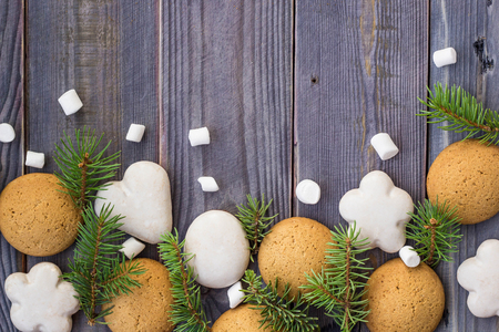 Christmas border with gingerbread, marshmallow and branch of fir tree.の写真素材
